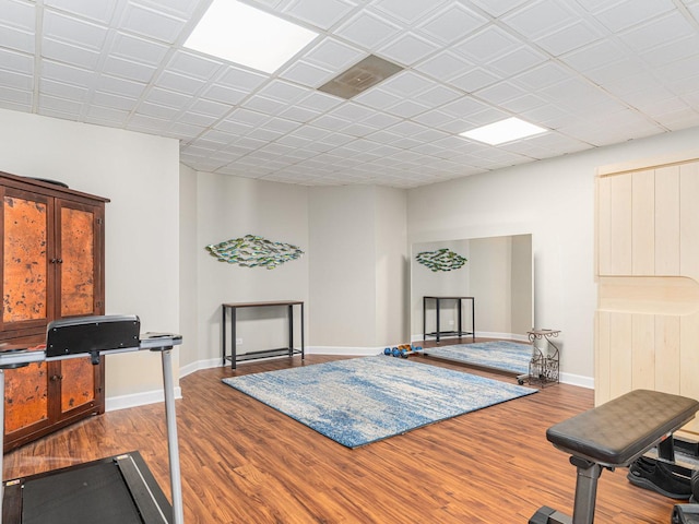 workout area featuring baseboards and wood finished floors
