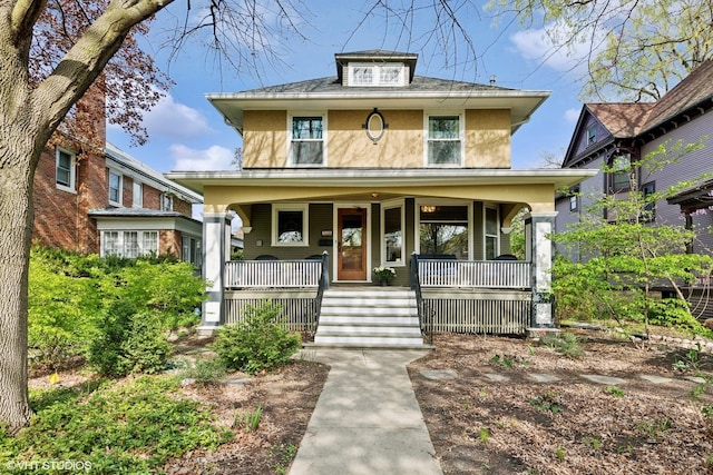 traditional style home featuring a porch and stucco siding