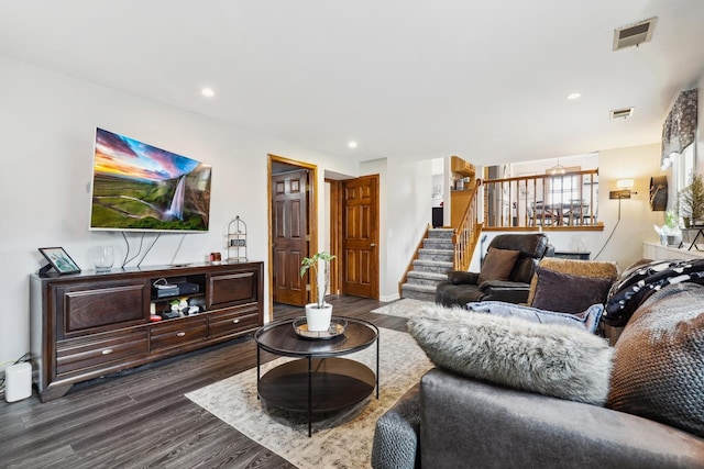 living area with recessed lighting, visible vents, dark wood-style floors, and stairway