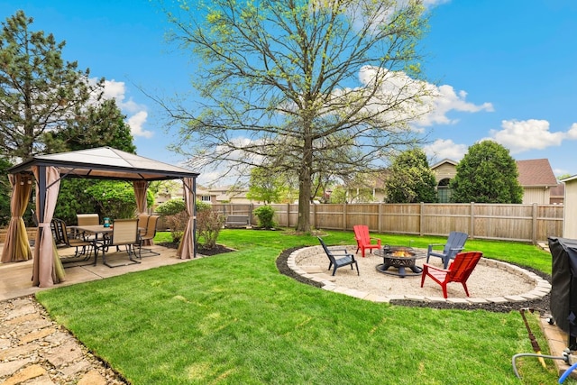 view of yard featuring a fenced backyard, a patio, a gazebo, and a fire pit