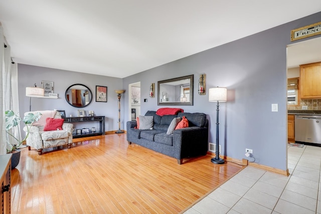 living room featuring baseboards and light wood-style flooring
