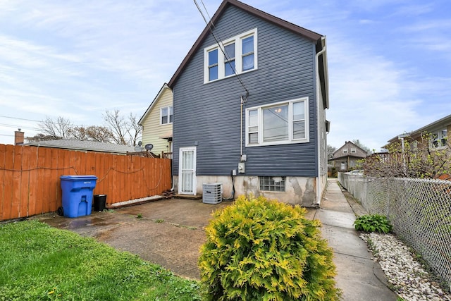 13134 S Burley Ave, Chicago, IL 60633 - rear view of house with a fenced backyard, central air condition unit, and a patio area