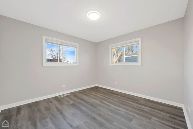 689 E 155th St, South Holland, IL 60473 - empty room featuring baseboards, visible vents, and dark wood-type flooring