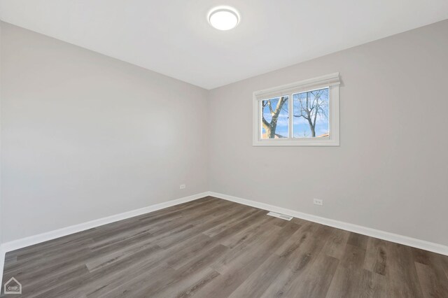 689 E 155th St, South Holland, IL 60473 - unfurnished room featuring baseboards, visible vents, and wood finished floors
