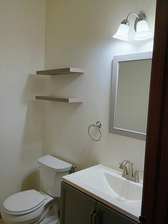 bathroom featuring toilet and vanity