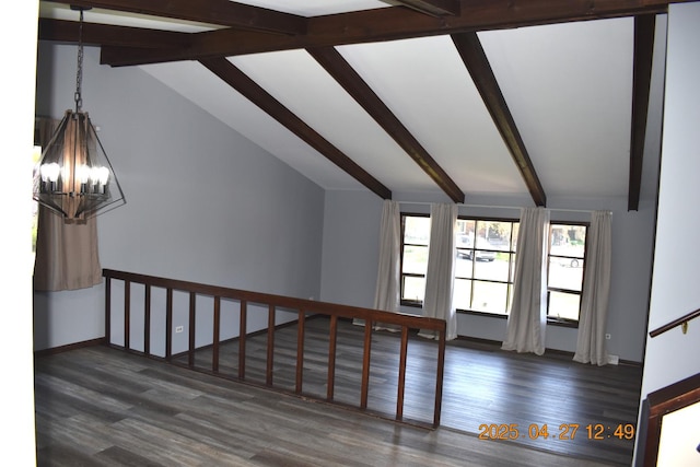 interior space featuring baseboards, lofted ceiling with beams, wood finished floors, and a notable chandelier