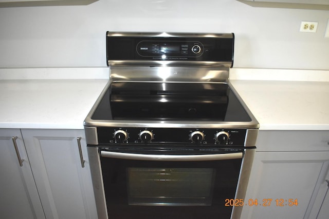 room details featuring light countertops, range with electric cooktop, and gray cabinets