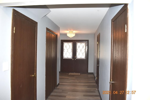hall with french doors and dark wood-type flooring