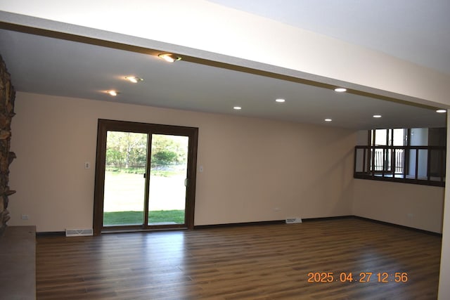 unfurnished room with baseboards, recessed lighting, wood finished floors, and visible vents