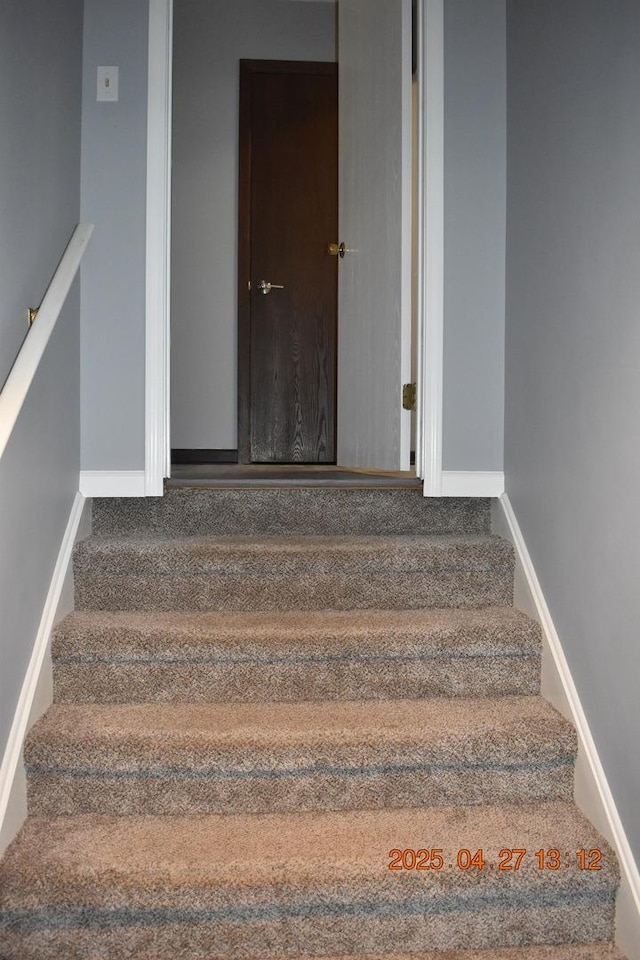 staircase featuring baseboards