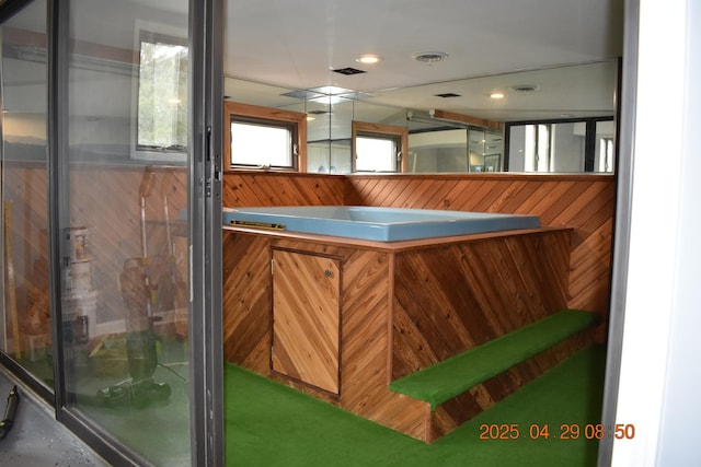 full bath with wooden walls and a shower with door