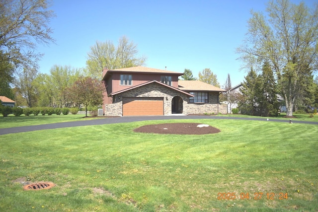 view of front of home featuring a front yard, aphalt driveway, and stone siding
