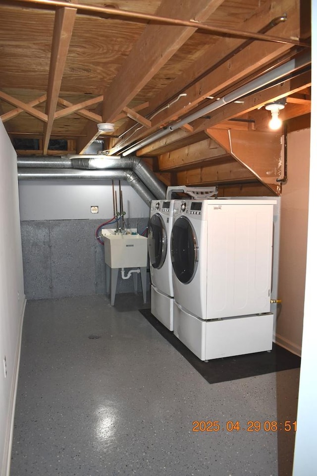 laundry area featuring a sink, separate washer and dryer, baseboards, and laundry area