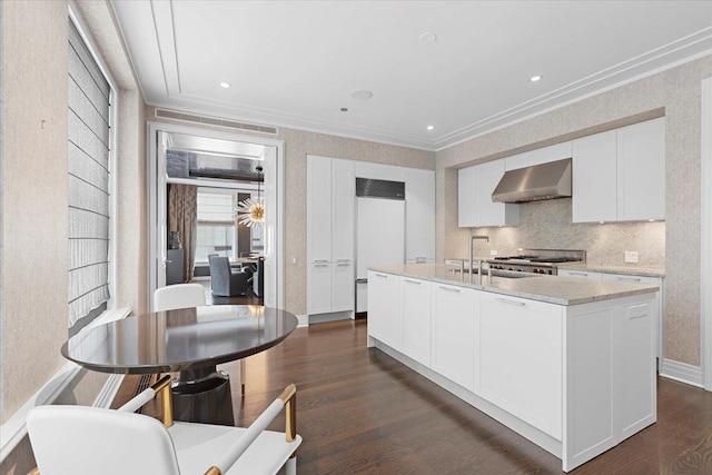 159 E Walton Pl Unit 5G, Chicago, IL 60611 - kitchen featuring wall chimney exhaust hood, ornamental molding, white cabinets, paneled built in fridge, and dark wood-style flooring