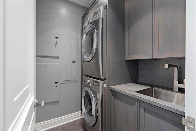 159 E Walton Pl Unit 5G, Chicago, IL 60611 - washroom with estacked washer and dryer, cabinet space, and dark tile patterned floors