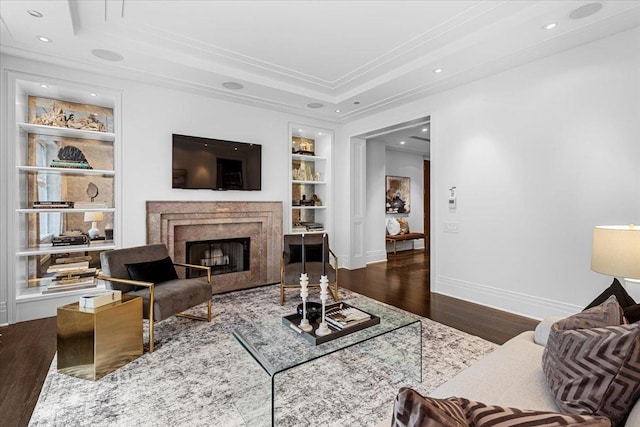 159 E Walton Pl Unit 5G, Chicago, IL 60611 - living room featuring a fireplace, wood finished floors, built in shelves, a tray ceiling, and ornamental molding