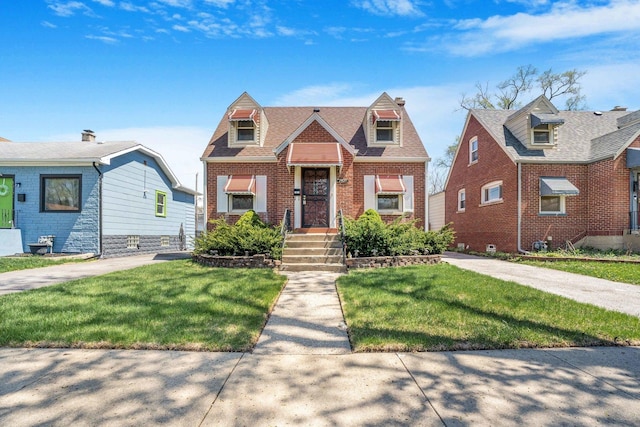 view of front of property with brick siding and a front yard