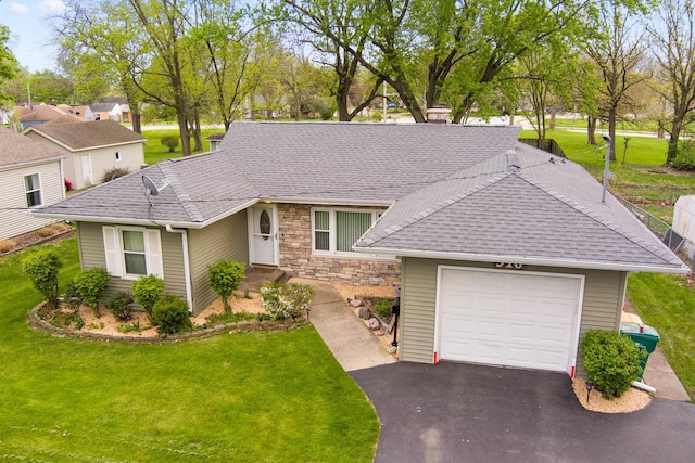 single story home featuring a shingled roof, an attached garage, driveway, a front lawn, and stone siding