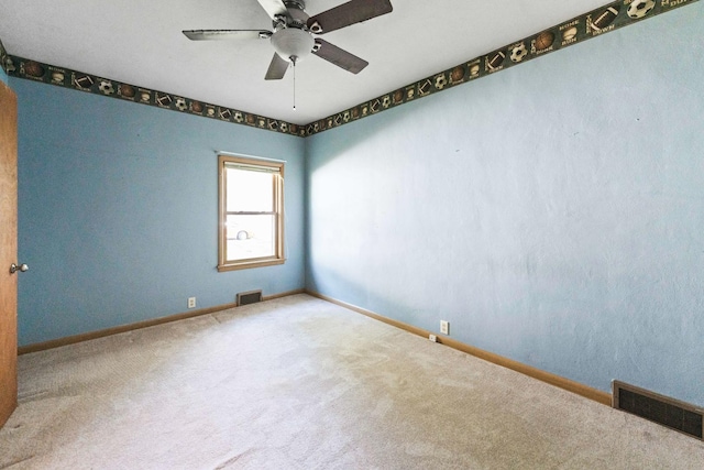 spare room with carpet floors, baseboards, and a ceiling fan