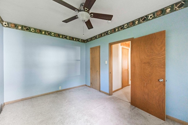 unfurnished bedroom featuring carpet floors, baseboards, and ceiling fan
