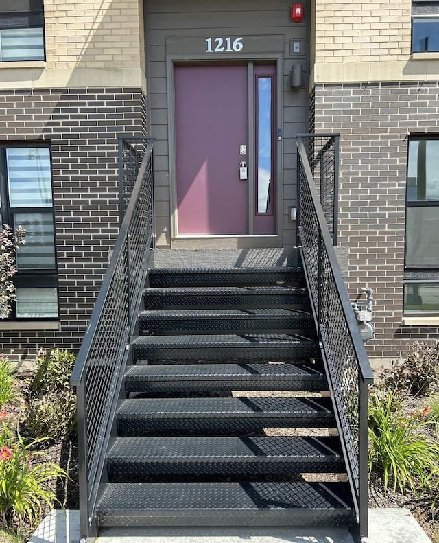 property entrance featuring brick siding