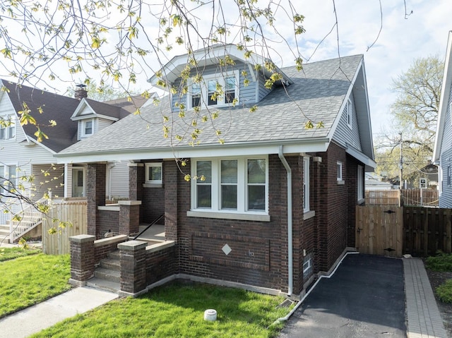 218 157th St, Calumet City, IL 60409 - bungalow-style house with a gate, brick siding, fence, roof with shingles, and a front lawn