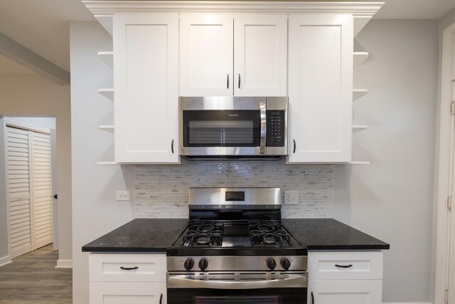 218 157th St, Calumet City, IL 60409 - kitchen with white cabinets, stainless steel appliances, open shelves, and decorative backsplash