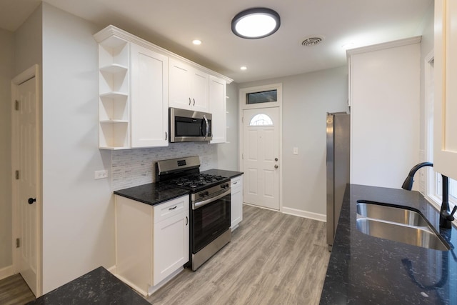 218 157th St, Calumet City, IL 60409 - kitchen featuring a sink, stainless steel appliances, open shelves, tasteful backsplash, and light wood-style flooring