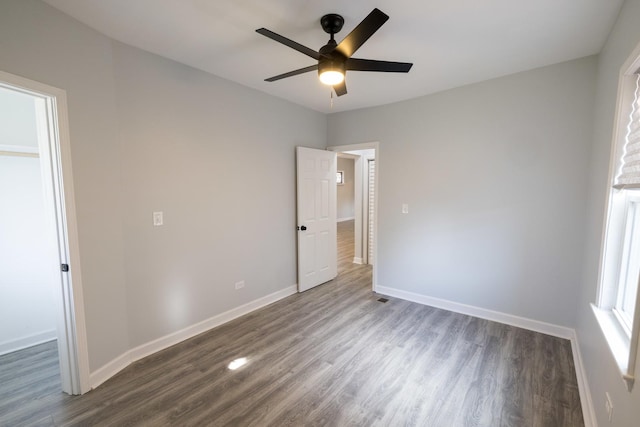 218 157th St, Calumet City, IL 60409 - unfurnished bedroom featuring a ceiling fan, dark wood-style flooring, and baseboards