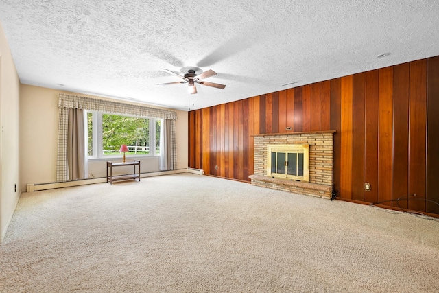 unfurnished living room with a ceiling fan, carpet, a textured ceiling, and wooden walls
