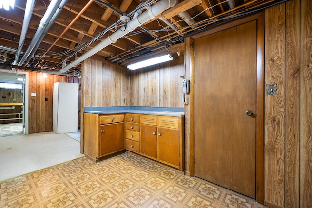 finished basement featuring wood walls and light floors