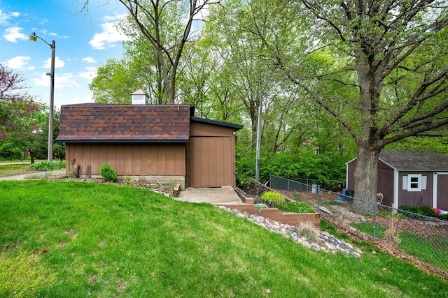 view of shed featuring fence