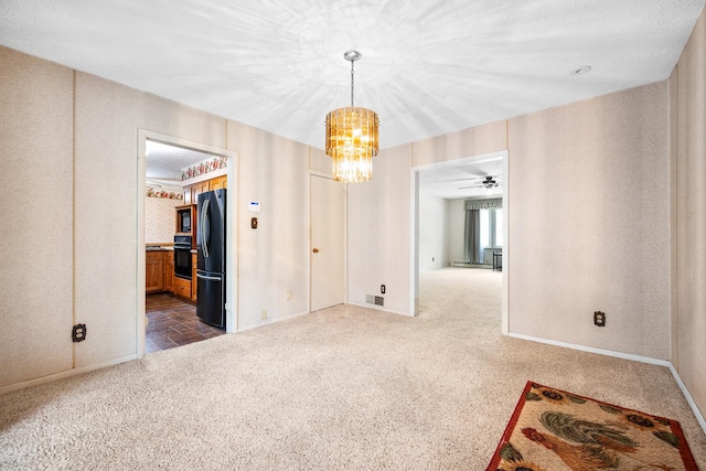 unfurnished dining area with baseboards, a notable chandelier, visible vents, and dark colored carpet