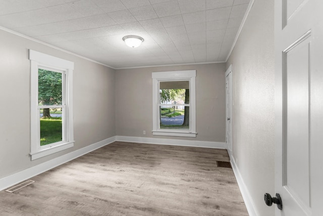 510 S Cottage Grove Ave, Urbana, IL 61802 - empty room featuring crown molding, healthy amount of natural light, and wood finished floors