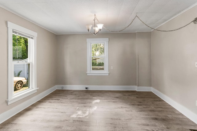 510 S Cottage Grove Ave, Urbana, IL 61802 - empty room featuring a chandelier, wood finished floors, and crown molding