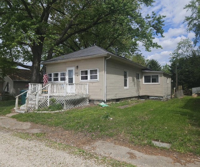 303 S Spruce St, Villa Grove, IL 61956 - view of front of property featuring a wooden deck and a front yard