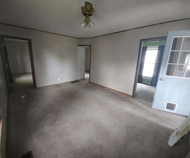 303 S Spruce St, Villa Grove, IL 61956 - carpeted spare room featuring baseboards and a ceiling fan