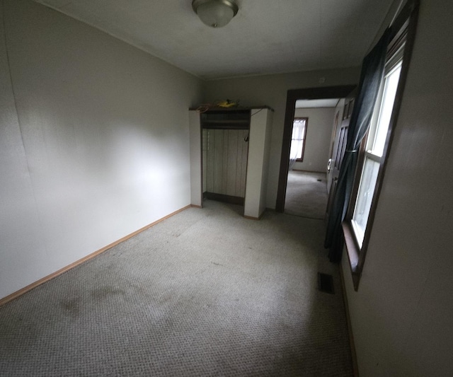 303 S Spruce St, Villa Grove, IL 61956 - unfurnished bedroom featuring light carpet and baseboards