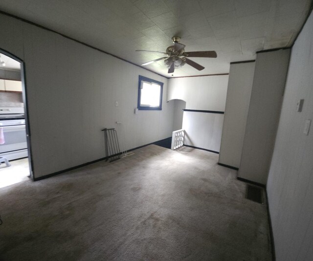 303 S Spruce St, Villa Grove, IL 61956 - carpeted empty room featuring arched walkways and a ceiling fan