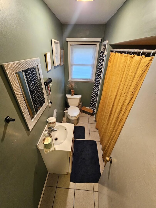 bathroom with tile patterned floors, a shower with shower curtain, toilet, and vanity