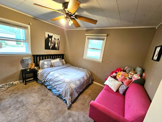bedroom with baseboards, ornamental molding, a ceiling fan, and carpet