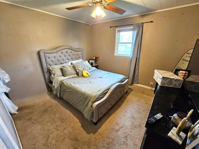 carpeted bedroom featuring ceiling fan and crown molding