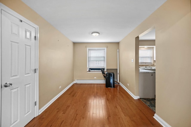 405 E 109th St Unit 203, Chicago, IL 60628 - unfurnished room with wood finished floors and a baseboard heating unit