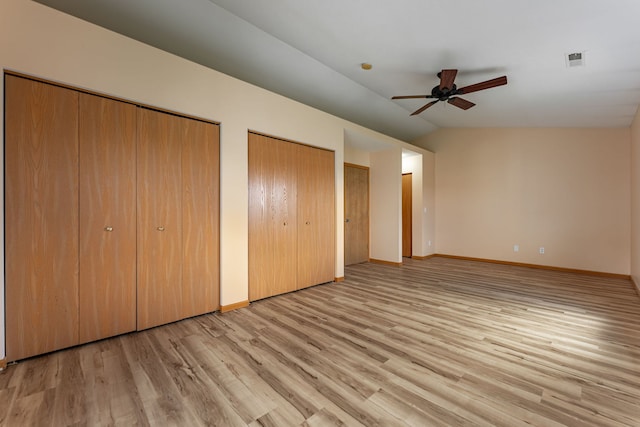7480 Thomas Dr Unit 7480, Loves Park, IL 61111 - unfurnished bedroom with baseboards, visible vents, wood finished floors, and two closets