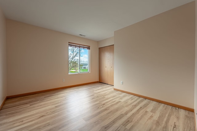 7480 Thomas Dr Unit 7480, Loves Park, IL 61111 - unfurnished room featuring visible vents, baseboards, and light wood-style floors