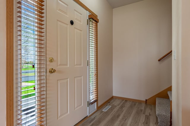 7480 Thomas Dr Unit 7480, Loves Park, IL 61111 - foyer with baseboards, visible vents, wood finished floors, and stairway