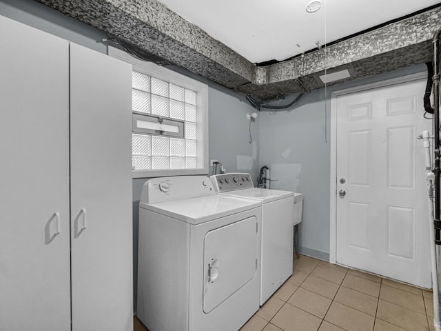 laundry room featuring laundry area, light tile patterned floors, and separate washer and dryer