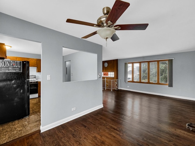 unfurnished living room featuring baseboards, a ceiling fan, and wood finished floors