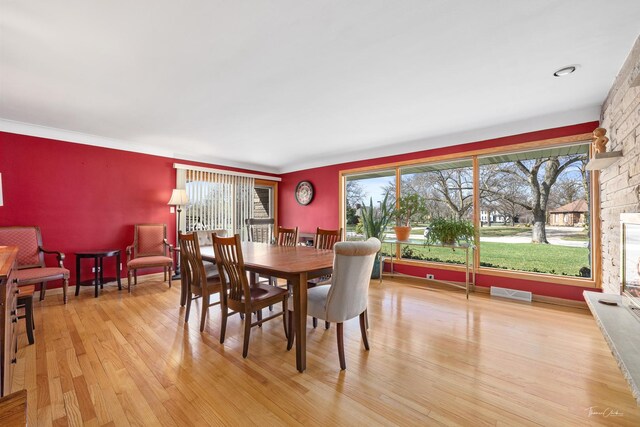 dining space featuring visible vents, a wealth of natural light, and light wood-style flooring