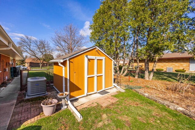 view of shed featuring central AC and fence